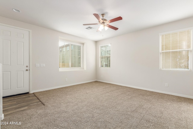 carpeted empty room with ceiling fan