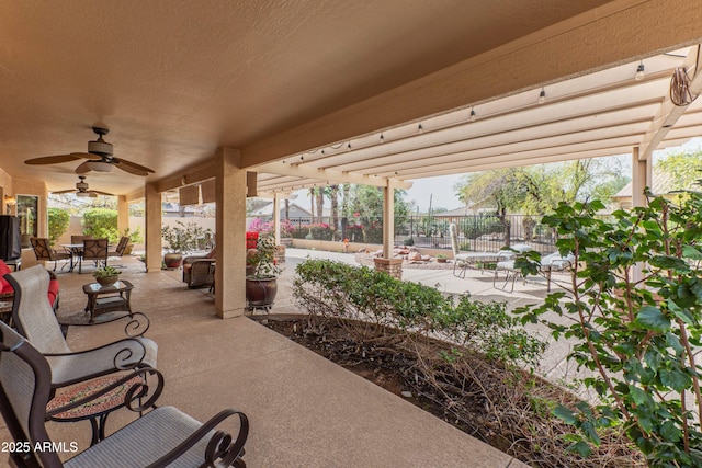 view of patio featuring fence, a ceiling fan, and outdoor dining space