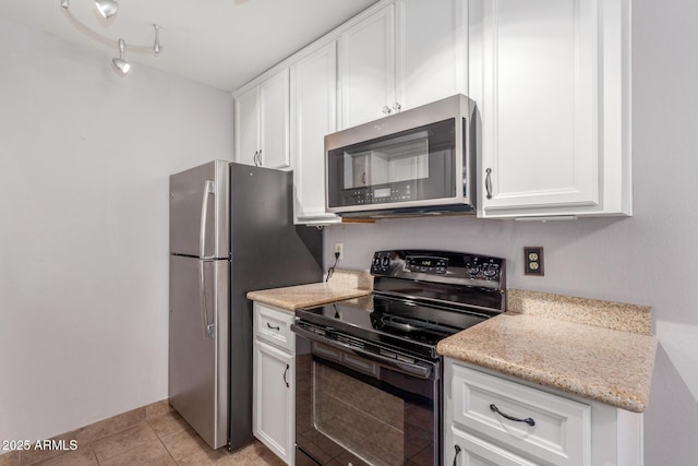 3500 N Hayden Rd Unit 801, Scottsdale, AZ 85251 - kitchen with appliances with stainless steel finishes, white cabinetry, light tile patterned floors, and light stone counters