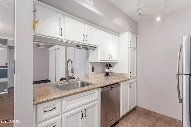 3500 N Hayden Rd Unit 801, Scottsdale, AZ 85251 - kitchen with appliances with stainless steel finishes, a sink, light countertops, and white cabinets