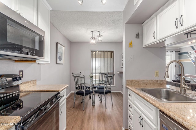 3500 N Hayden Rd Unit 801, Scottsdale, AZ 85251 - kitchen with stainless steel appliances, a sink, light wood finished floors, light countertops, and white cabinetry