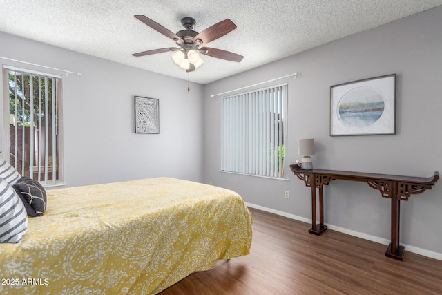 3500 N Hayden Rd Unit 801, Scottsdale, AZ 85251 - bedroom featuring wood finished floors, baseboards, a textured ceiling, and ceiling fan