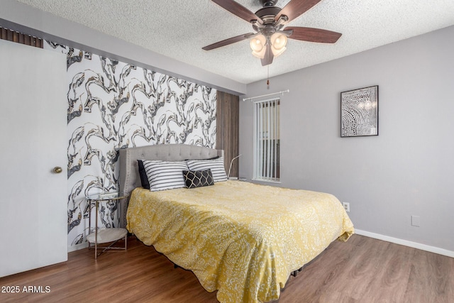 3500 N Hayden Rd Unit 801, Scottsdale, AZ 85251 - bedroom with wood finished floors, a textured ceiling, baseboards, and a ceiling fan