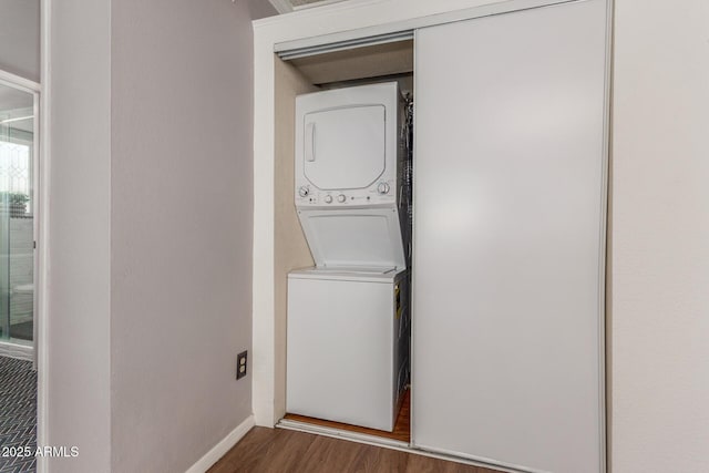 3500 N Hayden Rd Unit 801, Scottsdale, AZ 85251 - laundry room featuring stacked washer / dryer, wood finished floors, and baseboards