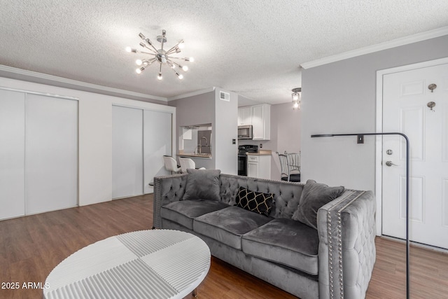 3500 N Hayden Rd Unit 801, Scottsdale, AZ 85251 - living area with a textured ceiling, crown molding, a chandelier, and wood finished floors
