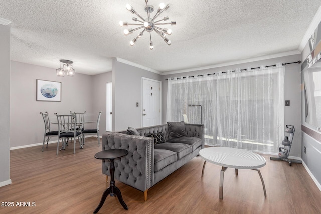 3500 N Hayden Rd Unit 801, Scottsdale, AZ 85251 - living area with a chandelier, light wood-style floors, crown molding, a textured ceiling, and baseboards