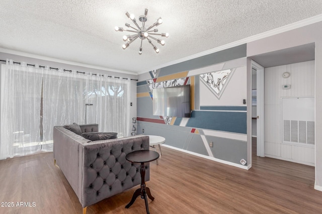 3500 N Hayden Rd Unit 801, Scottsdale, AZ 85251 - interior space featuring a chandelier, a textured ceiling, wood finished floors, ornamental molding, and a decorative wall