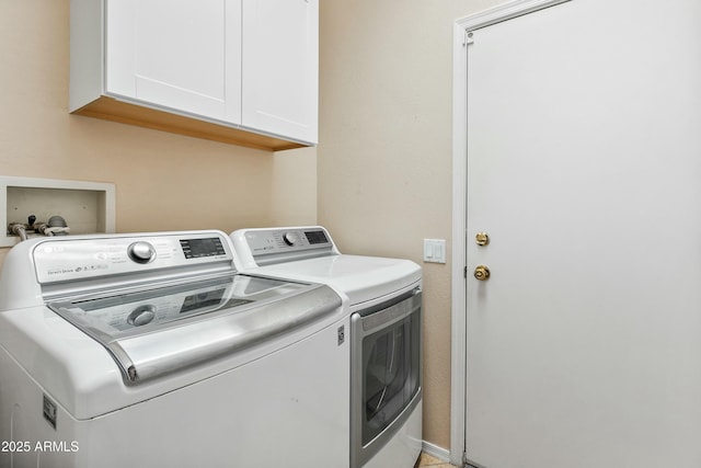 laundry area with cabinets and washing machine and clothes dryer