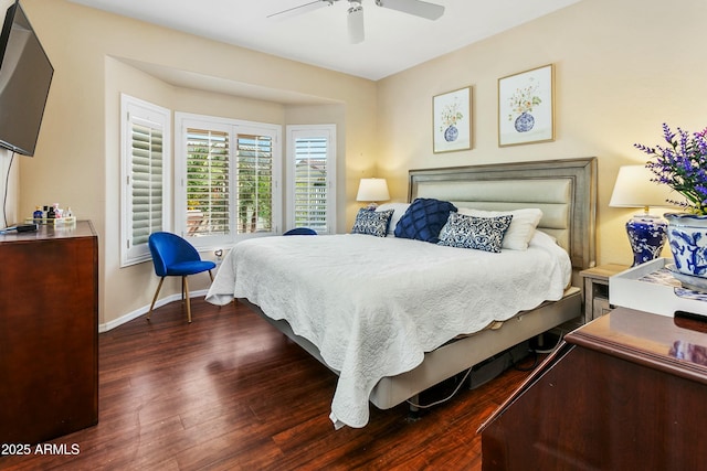 bedroom with dark hardwood / wood-style flooring and ceiling fan