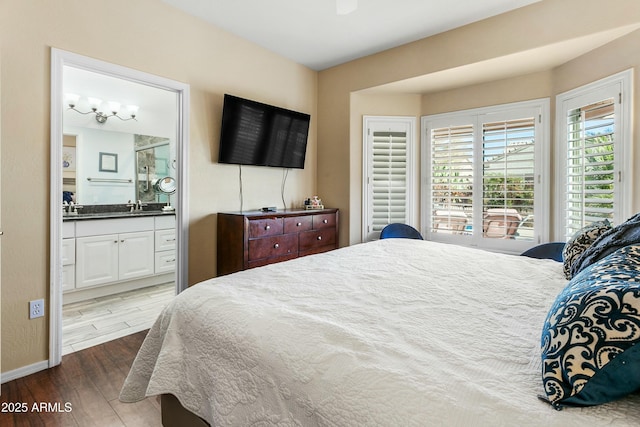 bedroom featuring wood-type flooring and connected bathroom