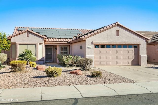 view of front of property with a garage and solar panels