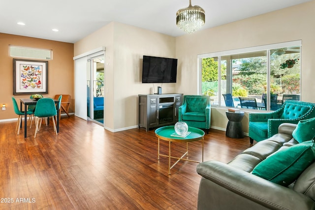 living room with hardwood / wood-style floors and a chandelier