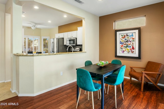 dining room featuring dark wood-type flooring and ceiling fan