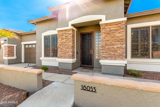 doorway to property with a garage