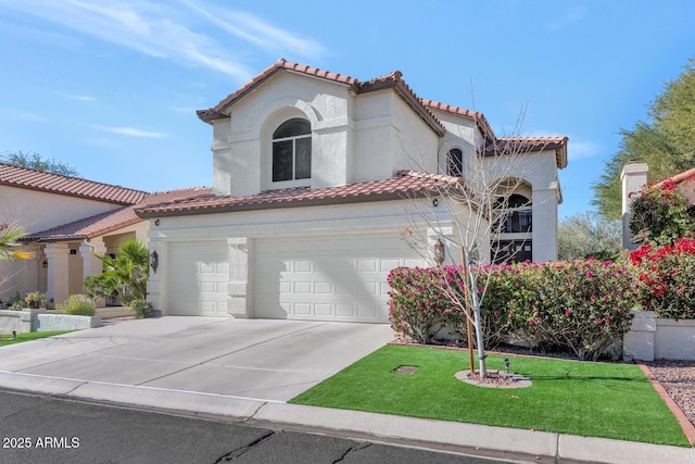 mediterranean / spanish house with a garage and a front yard