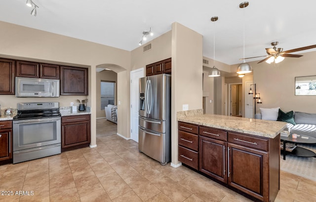 kitchen featuring decorative light fixtures, dark brown cabinetry, appliances with stainless steel finishes, and kitchen peninsula