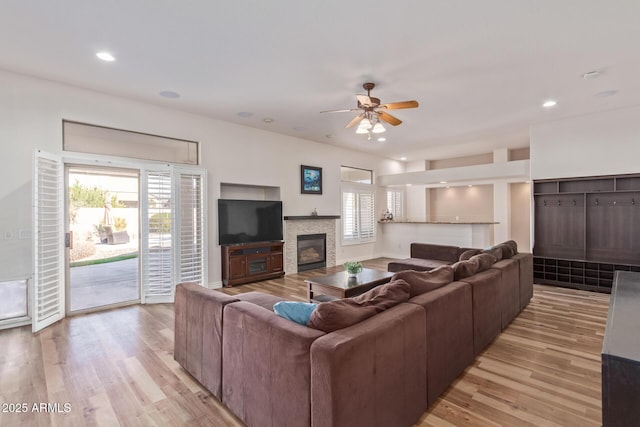 living room featuring ceiling fan and light hardwood / wood-style floors