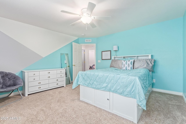 carpeted bedroom with vaulted ceiling and ceiling fan