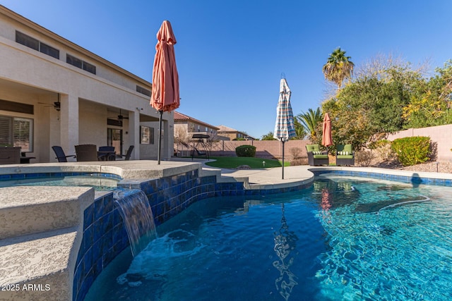 view of swimming pool featuring pool water feature, ceiling fan, and a patio