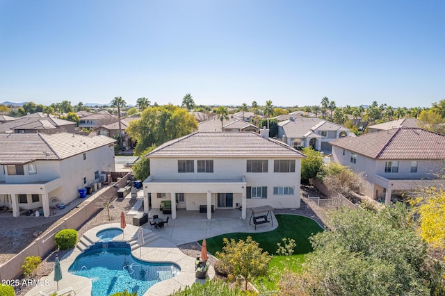 back of property featuring a fenced in pool, a patio, and an outdoor hangout area