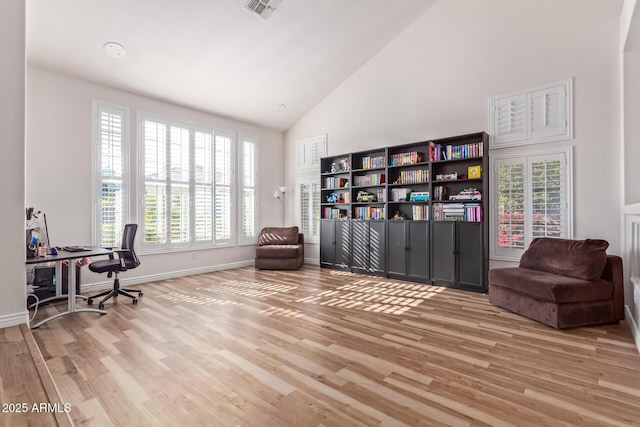 office area featuring a wealth of natural light, light hardwood / wood-style flooring, and high vaulted ceiling