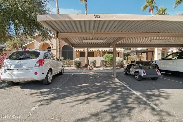 view of parking / parking lot featuring a carport