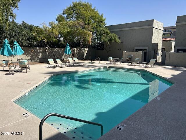 pool featuring a patio and fence