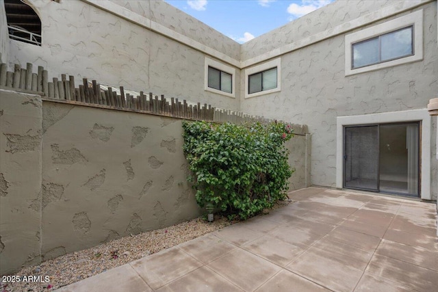 view of patio featuring fence