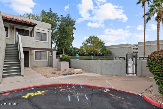 view of patio with a fenced front yard, stairs, and a gate