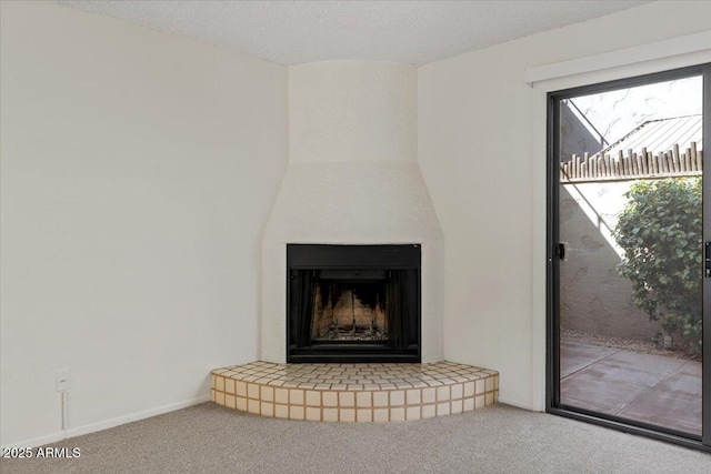 interior details featuring carpet, baseboards, and a large fireplace