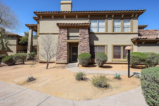19700 N 76th St Unit 1124, Scottsdale, AZ 85255 - view of front of home featuring a tile roof, stucco siding, and a chimney