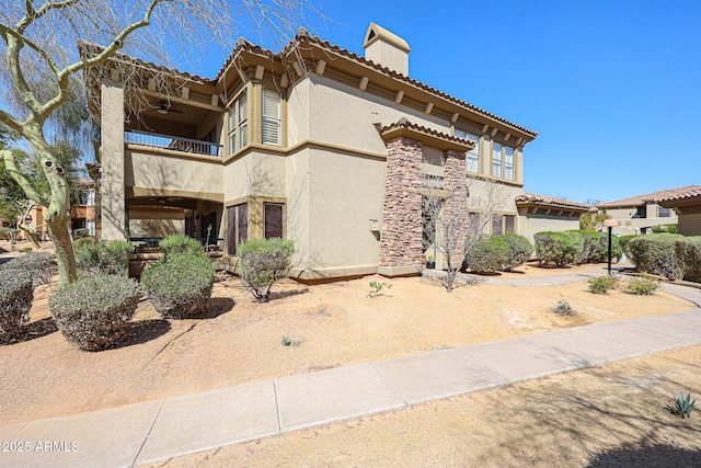 19700 N 76th St Unit 1124, Scottsdale, AZ 85255 - view of front of home with a tiled roof, a balcony, stucco siding, and ceiling fan