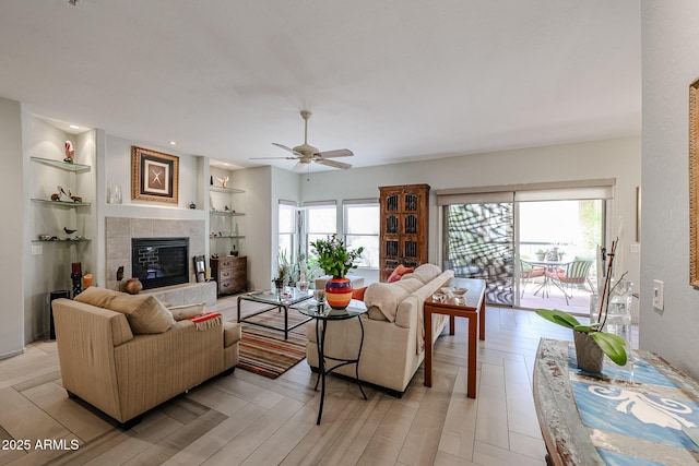 19700 N 76th St Unit 1124, Scottsdale, AZ 85255 - living room featuring plenty of natural light, a tiled fireplace, light wood-style flooring, and ceiling fan