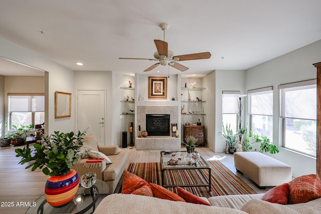 19700 N 76th St Unit 1124, Scottsdale, AZ 85255 - living room featuring wood finished floors, recessed lighting, a tiled fireplace, a ceiling fan, and built in features