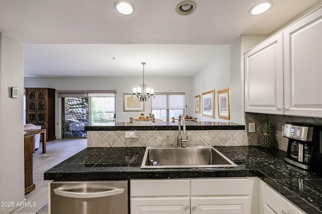 19700 N 76th St Unit 1124, Scottsdale, AZ 85255 - kitchen featuring a sink, a peninsula, stainless steel dishwasher, white cabinets, and decorative backsplash