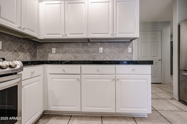 19700 N 76th St Unit 1124, Scottsdale, AZ 85255 - kitchen with white cabinets, light tile patterned flooring, tasteful backsplash, and stainless steel electric range
