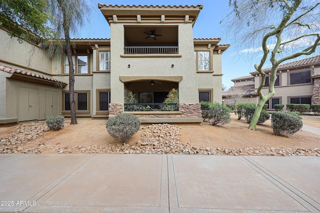 19700 N 76th St Unit 1124, Scottsdale, AZ 85255 - view of front of home featuring a tile roof, a ceiling fan, a balcony, and stucco siding