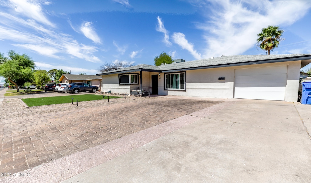 ranch-style home featuring a garage