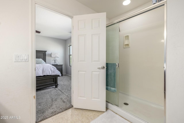 bathroom with tile patterned flooring and a shower with shower door