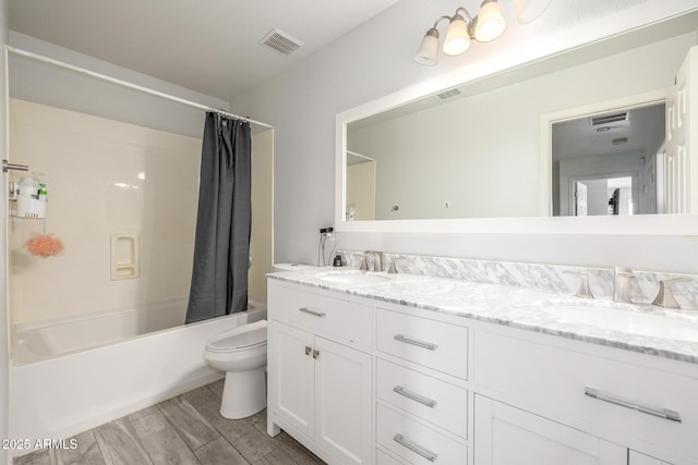 full bathroom with vanity, hardwood / wood-style floors, toilet, and shower / tub combo with curtain