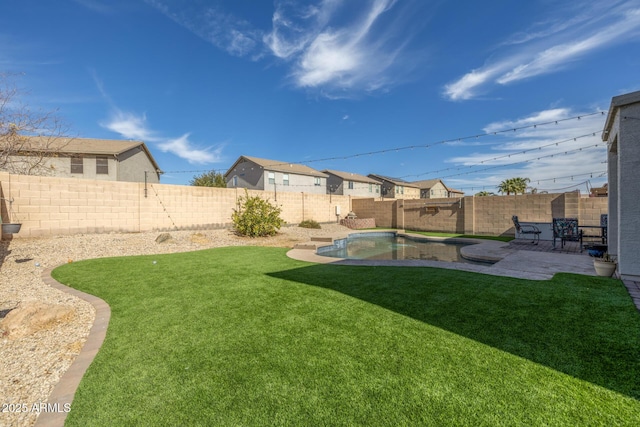 view of yard with a fenced in pool and a patio area