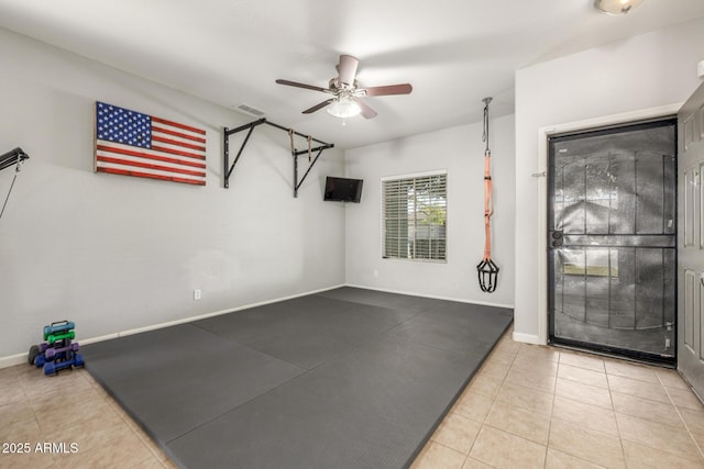 workout area featuring tile patterned flooring and ceiling fan