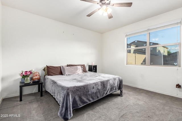 carpeted bedroom featuring a ceiling fan and baseboards