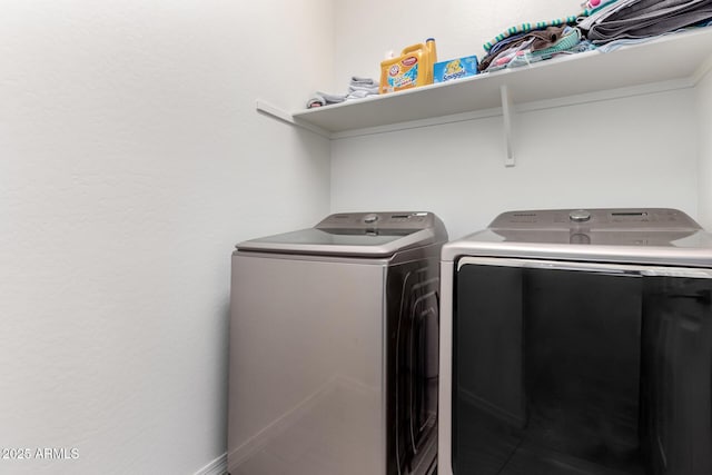 washroom featuring laundry area and washing machine and clothes dryer