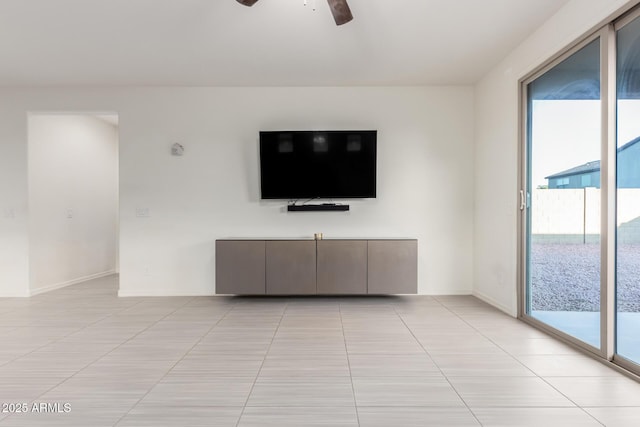 unfurnished living room with ceiling fan and light tile patterned floors