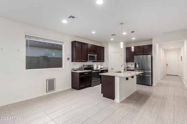 kitchen with a kitchen breakfast bar, appliances with stainless steel finishes, visible vents, and dark brown cabinetry