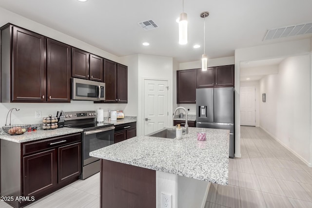 kitchen with dark brown cabinetry, visible vents, stainless steel appliances, and a sink