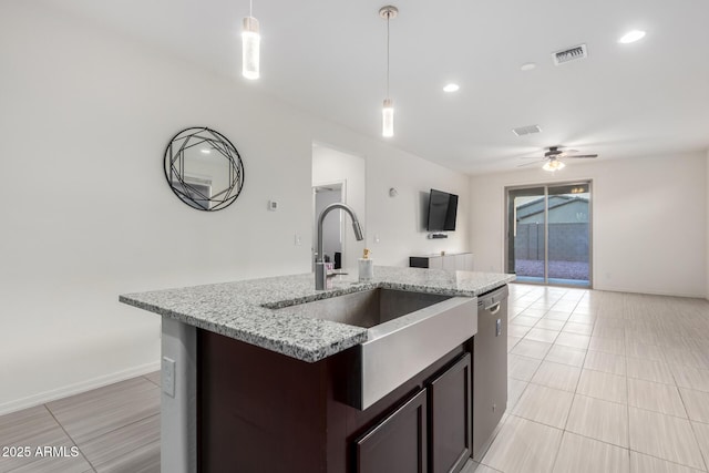 kitchen with visible vents, dishwasher, open floor plan, pendant lighting, and a sink