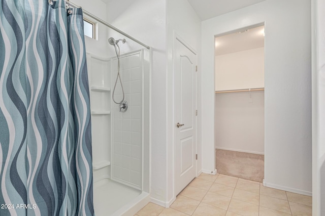 bathroom featuring tile patterned flooring and a shower with shower curtain