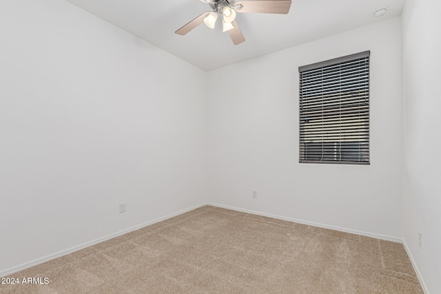 empty room with ceiling fan and light colored carpet